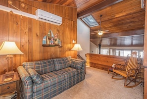 A cozy room with a plaid sofa, wooden rocking chair, and a skylight. - Four Hooppole South G6 by Taylor Made Deep Creek (Oakland)