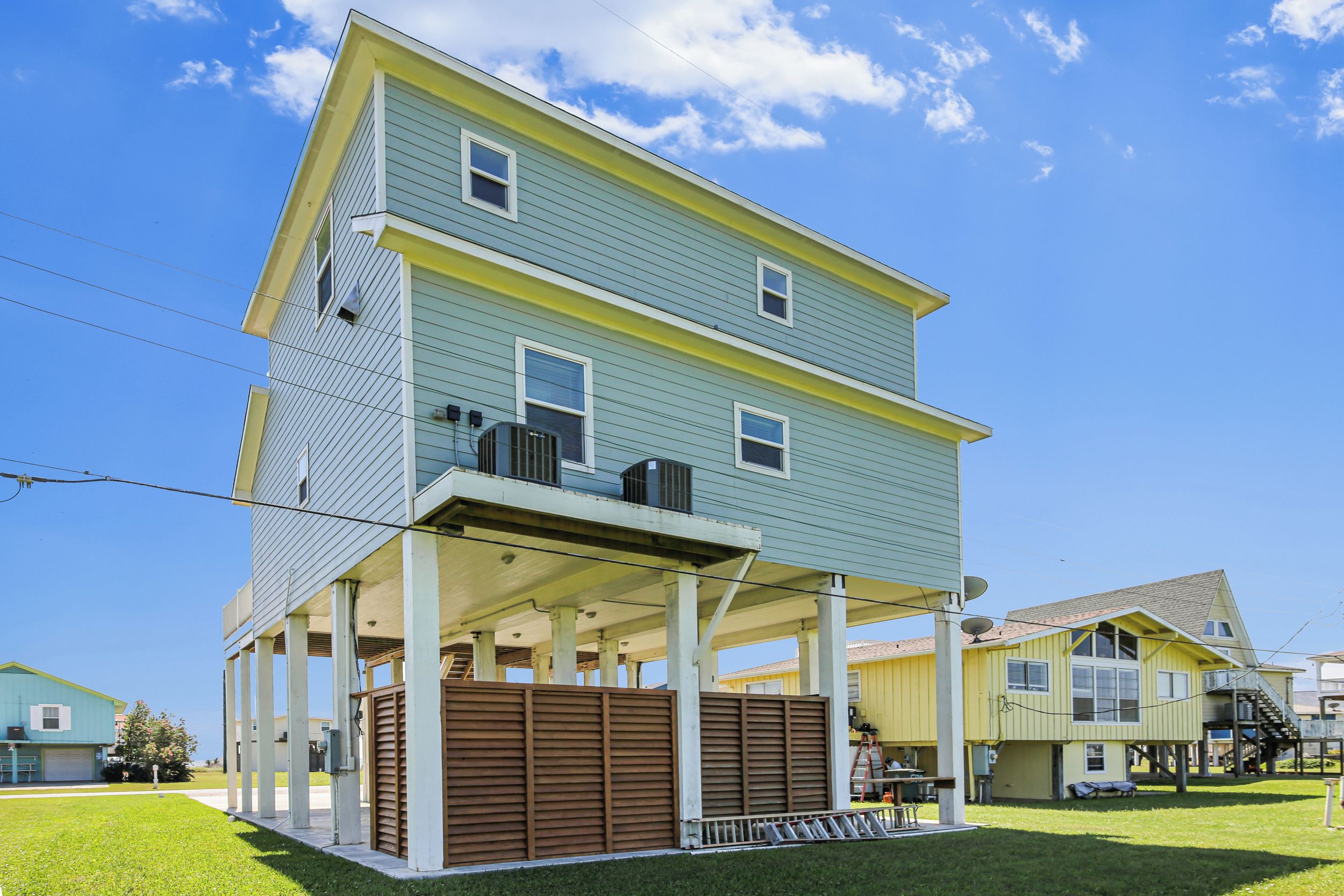 A two-story house with a covered porch and a fenced backyard.