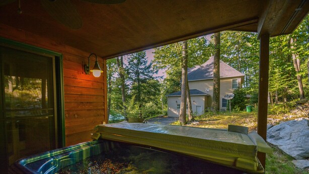 A hot tub with a view of a house and trees. - Hidden Treasure by Taylor Made Deep Creek (Oakland)