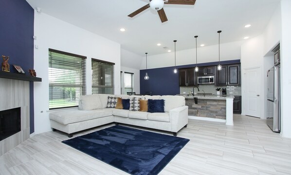 Relax in this inviting living space with a comfortable sofa and adjacent kitchen.
