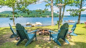 Two Adirondack chairs facing a fire pit with a lake view. - Lakeside Vista by Taylor Made Deep Creek (Oakland)