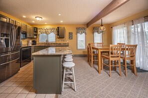 Enjoy meal preparation and casual dining in this inviting kitchen with a central island and adjacent dining area.