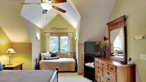 A bedroom with a bed, a dresser, a television, and a ceiling fan. - Midnight Dip by Taylor Made Deep Creek (Swanton)