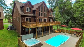 A two-story wooden house with a deck, a hot tub, and a swimming pool. - Midnight Dip by Taylor Made Deep Creek (Swanton)