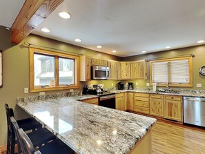 Enjoy cooking in this well-equipped kitchen with a central island and modern appliances.