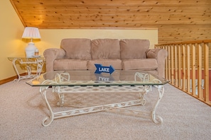 Relax in a stylish space with a sofa, coffee table, and decorative accents.