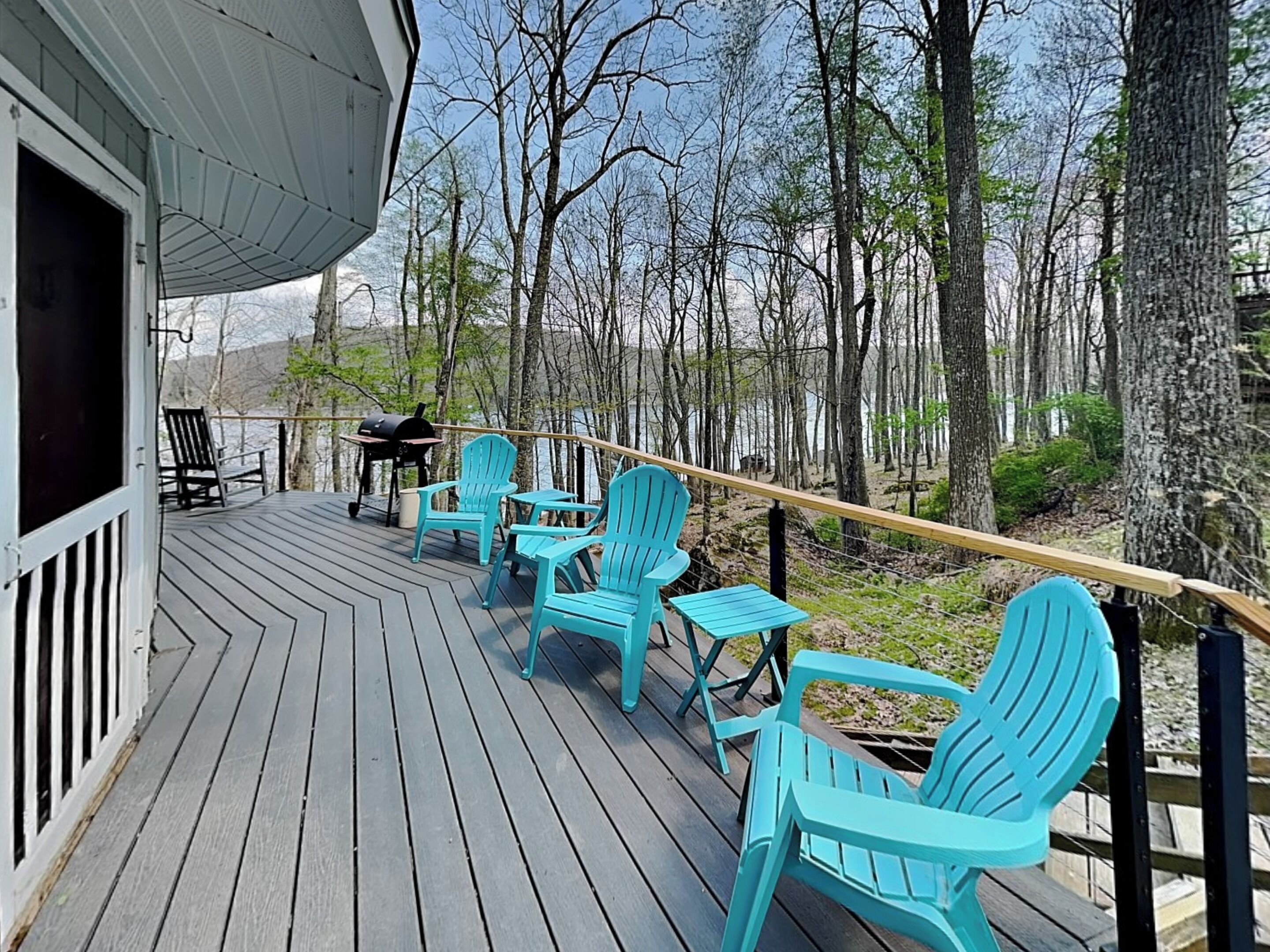 A deck with outdoor seating and a grill.