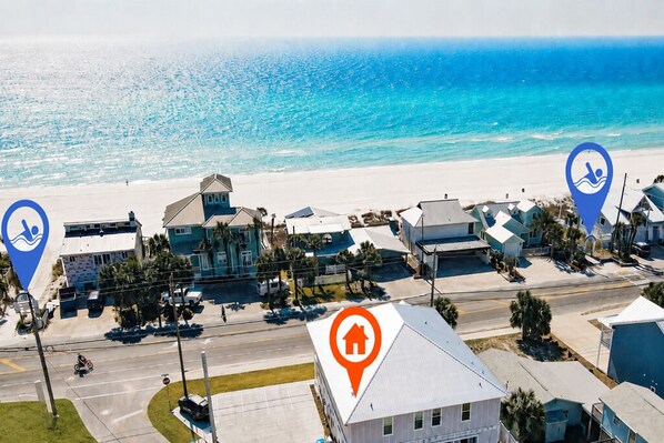 Une zone résidentielle côtière comprenant des maisons, une plage et une route.