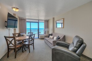 Enjoy ocean views from the balcony and relax in the comfortable seating area with a sofa and armchairs.