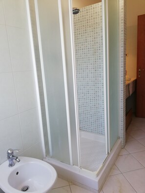 Een douche, een haardroger, een bidet, handdoeken