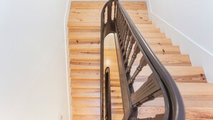 Una scala in legno con ringhiera in metallo.