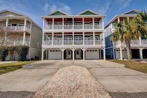 A multi-story residential building with a central entrance, balconies, and attached garages. - 2 Minutes to the Beach, Ocean Views, Side by Side Homes, Rent Separate/Together (Kure Beach)