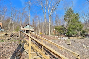 A wooden staircase leading to a gazebo in a wooded area. - Sm'oars by Taylor Made Deep Creek (McHenry)