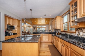 Enjoy cooking in this well-equipped kitchen with a central island, sink, oven, and microwave.