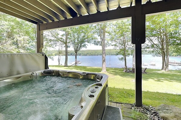 A hot tub under a covered area with a view of a lake and trees. - Stargazer by Taylor Made Deep Creek (Oakland)