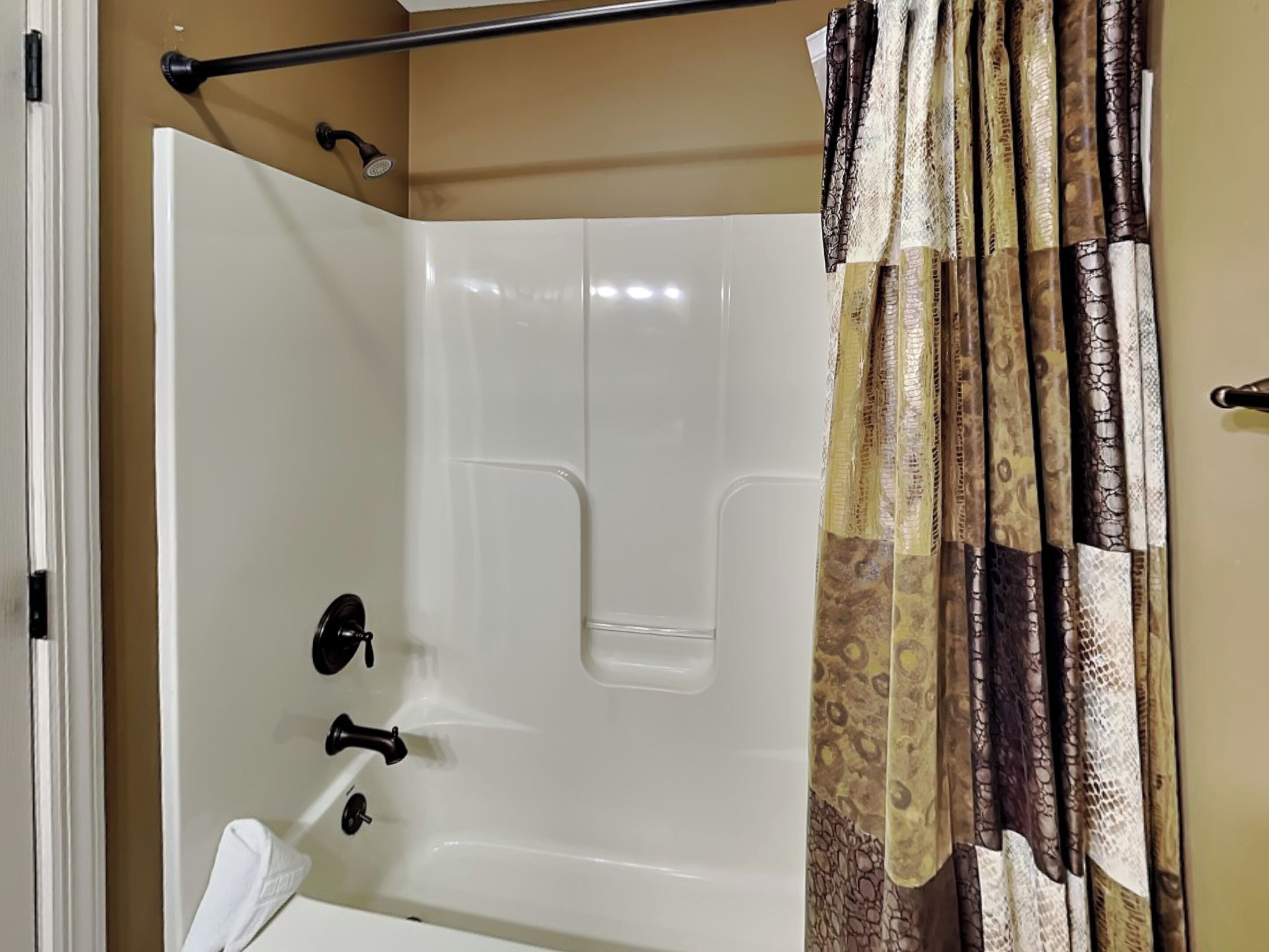 A bathroom with a bathtub, a shower, and a toilet.