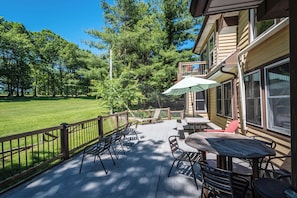 A covered patio with outdoor furniture, a table, and a chair. - Sunkissed Lodge by Taylor Made Deep Creek (McHenry)