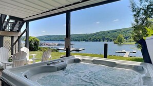 A hot tub with a view of a lake and docked boats. - Sunny Boy by Taylor Made Deep Creek (McHenry)