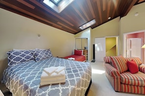 A bedroom with a bed, a sofa, a desk, and a wardrobe. - Sunset View by Taylor Made Deep Creek (Swanton)