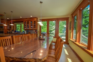 Enjoy cooking in this well-equipped kitchen with a central island and sink, offering views of the surrounding greenery.