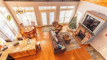 A spacious living room with a fireplace, a dining area, and a cozy seating area.