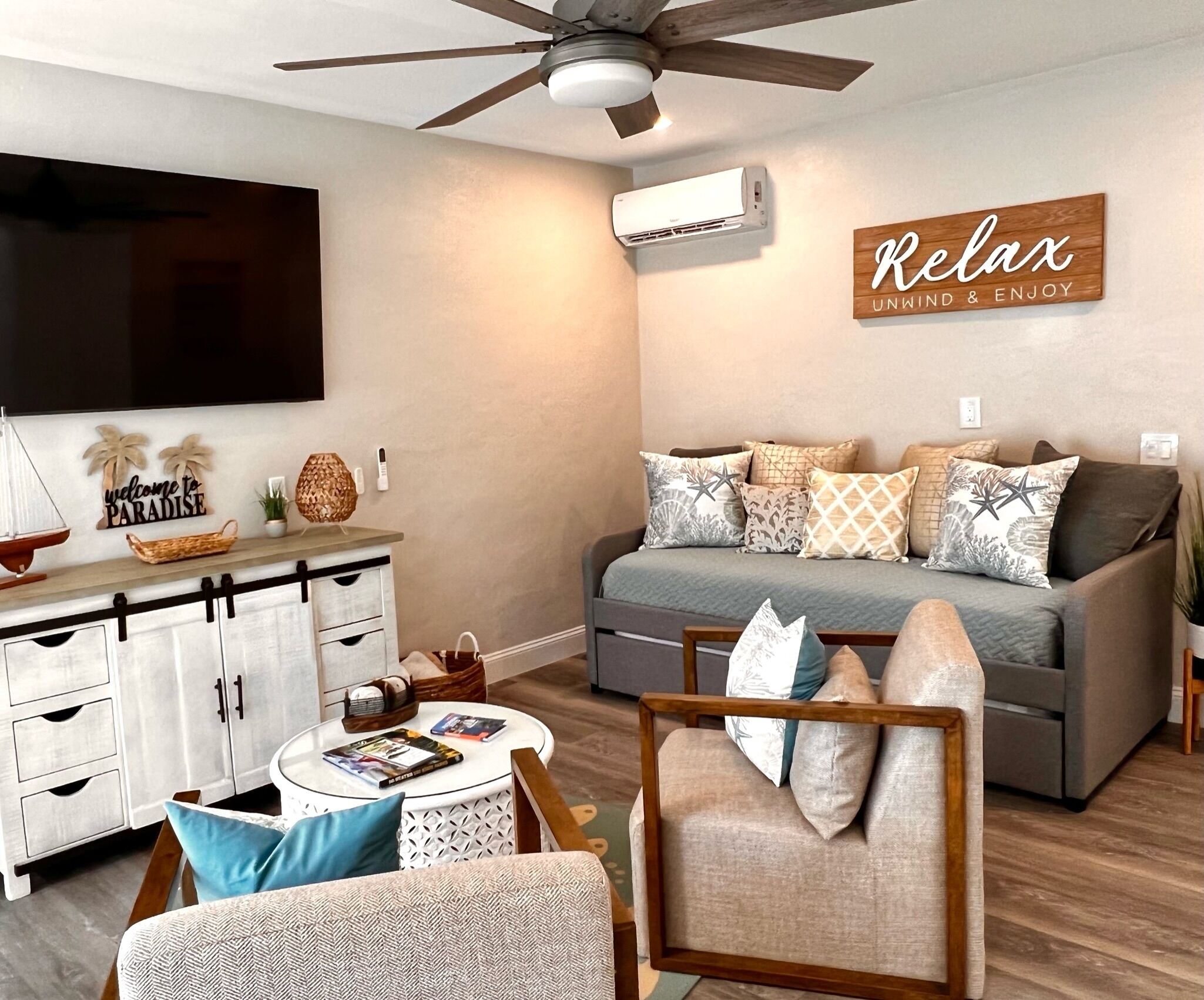 A modern living room with a sofa, a coffee table, and a TV.