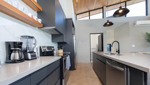 A modern kitchen with a built-in oven, a coffee maker, and a dishwasher.