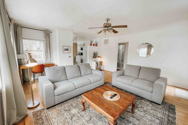 Living room with plenty of comfortable seating and an abundance of natural light.