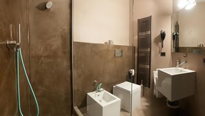 A modern bathroom with a glass shower enclosure, two white sinks, and a large mirror. - [Porta Nuova Suite] 24/7 Self Check-in (Verona)
