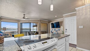 A modern kitchen with a large window, a built-in stove, and a ceiling fan. - Exquisite Lakefront Condo - Pool - Boat Slip (Hot Springs)