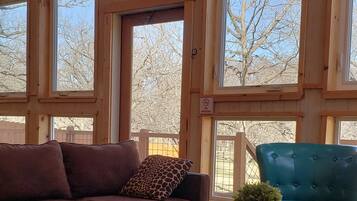 Deluxe Cabin | Living area | 34-inch TV with satellite channels