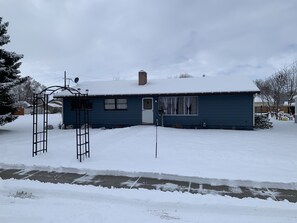 A single-story house with a blue exterior, a front door, and a small porch area. - Our little Gem, remodeled and new everything. Close to down town. (Emmett)