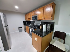 A kitchen with wooden cabinets, a stainless steel refrigerator, a microwave, a stove, and a sink. - $245/Amazing 3LV, 4BR TH, 3.5BTH close to Quantico (Stafford)