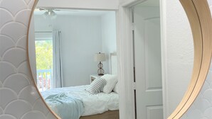 A bathroom with a round mirror, a sink, and a toilet. - Bimini Dreams, Steps from the Beach, optional Golf Cart rent (Bailey Town)
