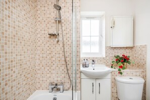 Combined shower/bathtub, hair dryer, towels, soap