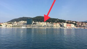 A coastal cityscape with a prominent hill in the background. - Studio apartment Miko - top location, great place to enjoy (Split)