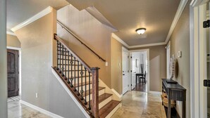 A home interior with a staircase, a dining area, and a hallway. - Luxe Canyon Lake Home w/ Gorgeous Lake Views! (Canyon Lake)
