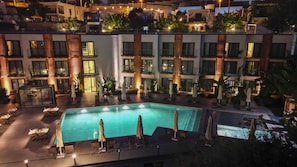 A hotel with a swimming pool, outdoor seating, and a well-lit terrace. - Bodrum Astrid Hotel  (Bodrum)