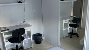 A bedroom with a bed, a desk with a chair, a television, and a mirror. - Rooms in house (Gercourt-et-Drillancourt)