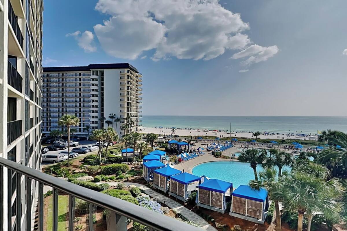 A resort with a pool, beach, and high-rise buildings.