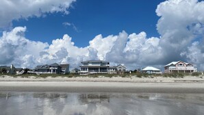 A beachfront property with multiple houses, a sandy beach, and a clear blue sky with clouds. - A FEW STEPS TO OCEAN in EMERALD ISLE, NC! Come visit walk to all entertainment! (Emerald Isle)