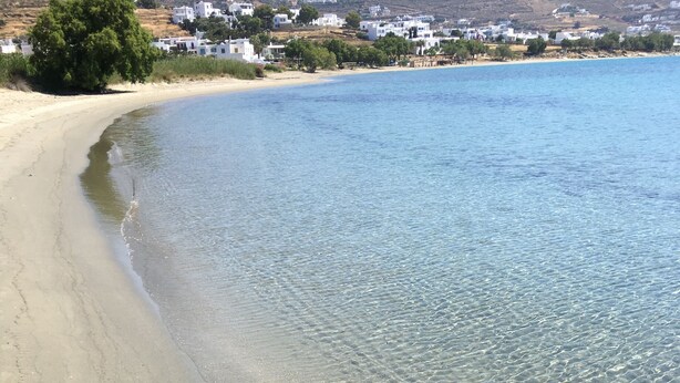 A beach with clear shallow waters and a sandy shore. - Tinos Agios Sostis Villa Filippos  five (5) min  walk to the beach - Pet Allowed (Agios Sostis Tinos)
