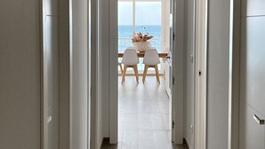 A hallway leading to a dining area with a view of the ocean. - Waterfront apartment Levante beach , in waterfront promenade. Great views (Benidorm)