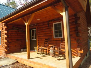 A log cabin with a porch, two rocking chairs, and a metal lantern. - Private log cabin on 3.5 acres (Fletcher)