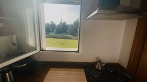 A kitchen with a window, a stove, and a sink. - Studio in a private estate in the center of the island (Sant Llorenç)