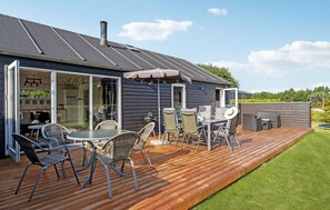 A deck with outdoor furniture, a grill, and a covered area with an umbrella. - Awesome home in Toftlund with WiFi (Toftlund)