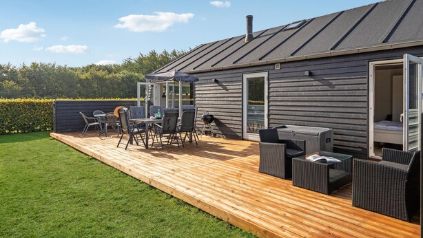 A deck with outdoor furniture, a grill, and a glass enclosure. - Awesome home in Toftlund with WiFi (Toftlund)