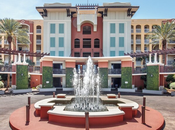 A hotel with a central fountain, multiple balconies, and a symmetrical facade. - TRAVEL EXPENSES PAID^ Elite Condo, Amazing Panoramic Water Views, Beach Service (Fort Walton Beach)