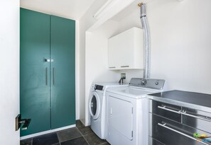 Washer and dryer with supplies stocked, available for guest use.