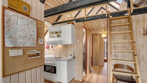 A wooden interior with a kitchen, a map on the wall, and a ladder. - Stunning home in Roslev with WiFi (Roslev)